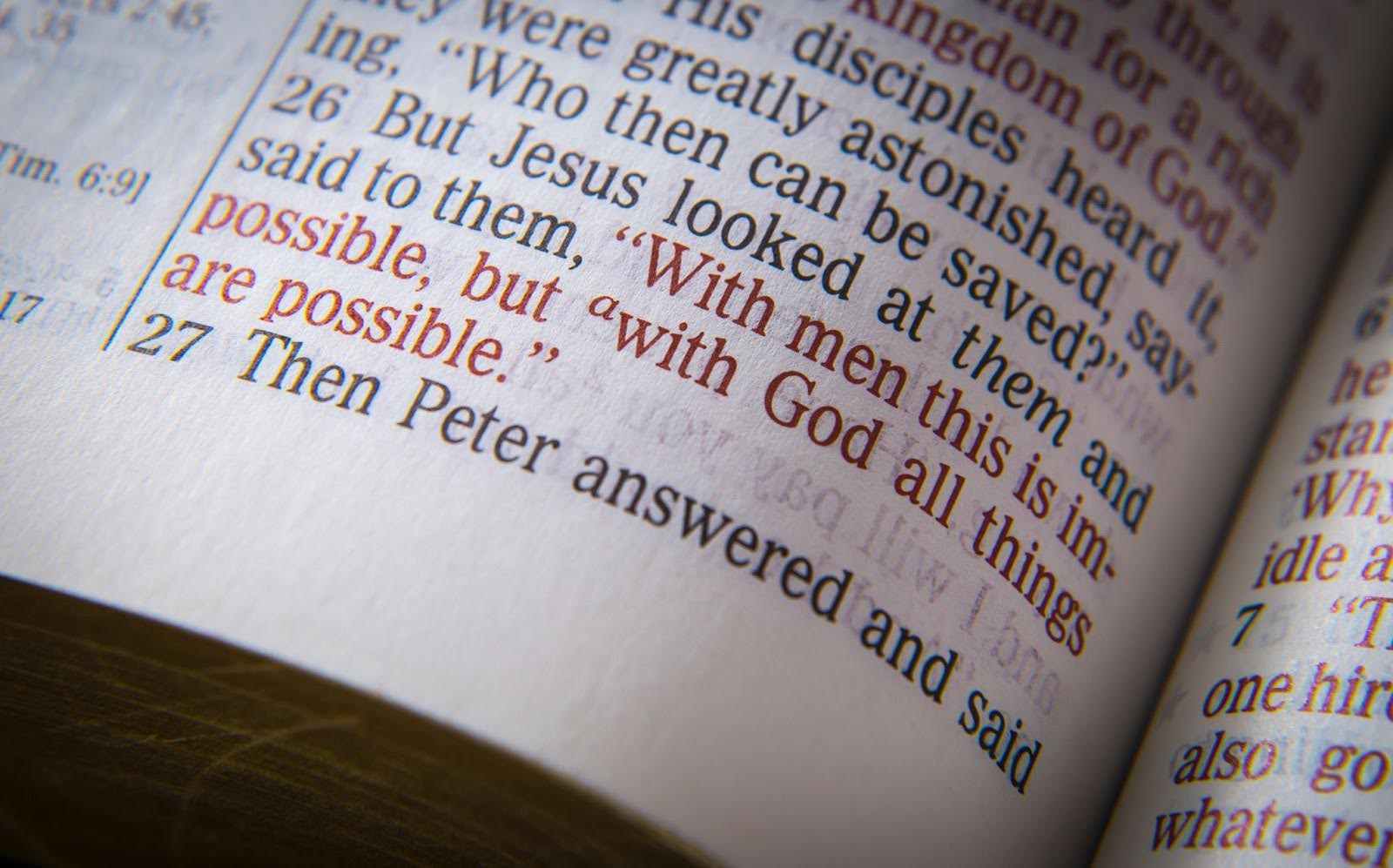 Close-up of a Bible page highlighting the verse “With God all things are possible” in red text.